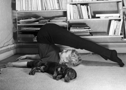 Woman exercising and dog sleeping
