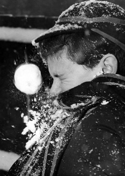 Boy with snowball in his face