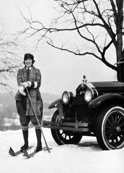 Woman on skis by car