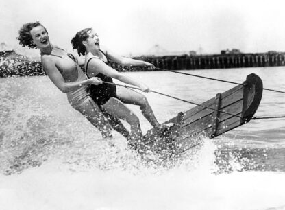 Two girls waterskiing