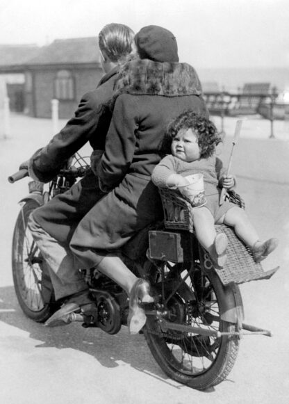 Toddler on back of motorbike