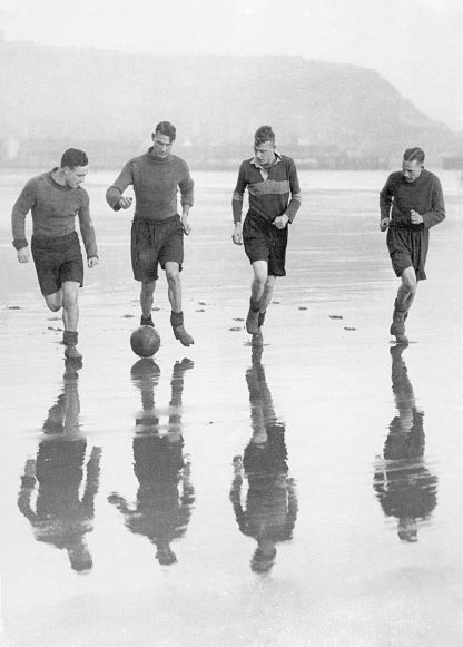 Footballers training on the beach