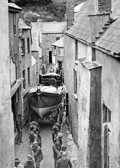 Boat being hauled through narrow street